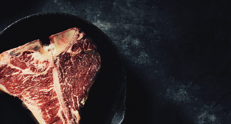 Woodward Meats dry aged t-bone steak in cast iron pan